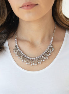 Infused with silver chain, silver pearls are threaded along an invisible wire below the collar. Matching silver pearls and glittery white rhinestones swing from the pearly strand, creating a flirtatious fringe below the collar. Features an adjustable clasp closure.  Sold as one individual necklace. Includes one pair of matching earrings.  Always nickel and lead free.
