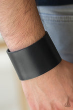 Load image into Gallery viewer, A thick black leather band wraps around the wrist for a bold urban look. Features an adjustable snap closure.  Sold as one individual bracelet.   Always nickel and lead free.