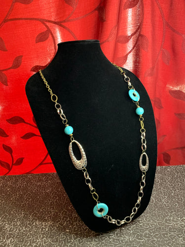 A compilation of refreshing turquoise stone beads, silver rings, brass rings, and hammered silver accents connect across the chest for an artisan flair. Features an adjustable clasp closure.  Sold as one individual necklace. Includes one pair of matching earrings.  Always nickel and lead free.