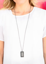 Load image into Gallery viewer, Featuring a regal emerald style cut, a faceted hematite rhinestone is pressed into the center of a glistening gunmetal frame bordered by dainty hematite rhinestones. The dramatic pendant swings from the bottom of a lengthened gunmetal chain for an edgy look. Features an adjustable clasp closure.  Sold as one individual necklace. Includes one pair of matching earrings.  Always nickel and lead free.