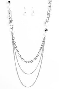 Polished white and faceted silver beads trickle along shimmery silver hoops for an asymmetrical look. The colorful beading gives way to layers of shimmery silver chain for a seasonal finish. Features an adjustable clasp closure.  Sold as one individual necklace. Includes one pair of matching earrings.