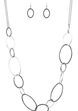 Load image into Gallery viewer, Swinging from doubled gunmetal chains, oversized asymmetrical hoops dramatically link across the chest for a refined industrial look. Features an adjustable clasp closure.  Sold as one individual necklace. Includes one pair of matching earrings.  Always nickel and lead free.