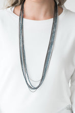 Load image into Gallery viewer, Brushed in a metallic finish, blue chains collide with mismatched gunmetal and silver chains across the chest. Shimmery silver and gunmetal popcorn chains join the colorful layers, adding shimmery metallic texture to the spunky mixed palette. Features an adjustable clasp closure.  Sold as one individual necklace. Includes one pair of matching earrings.  Always nickel and lead free.