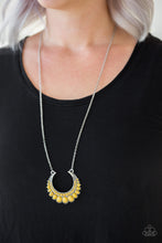 Load image into Gallery viewer, Gradually increasing in size towards the center, dainty yellow beads are encrusted along the center of a silver crescent frame. Yellow beads flare out from the bottom of the shimmery silver frame, creating a bold stationary pendant at the bottom of an elongated silver chain.