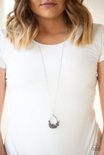 Load image into Gallery viewer, As if dipped in chaos, the bottom of a shimmery silver teardrop is encrusted in a collision of cube frames and mismatched hematite rhinestones. The edgy pendant swings from the bottom of a lengthened silver chain in a statement-making fashion. Features an adjustable clasp closure.  Sold as one individual necklace. Includes one pair of matching earrings.  Always nickel and lead free.