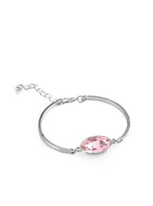 Arcing silver bars connect to a faceted pink gem centerpiece, creating a dainty cuff-like bracelet around the wrist. Features an adjustable clasp closure.  Sold as one individual bracelet.