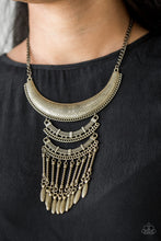 Load image into Gallery viewer, Stamped and embossed in tribal inspired patterns, three brass plates connect down the chest, creating a fiercely stacked pendant. Attached to twisted brass rods, ornate brass beads swing from the bottom of the lowermost plate, creating an eye-catching fringe. Features an adjustable clasp closure.  Sold as one individual necklace. Includes one pair of matching earrings.  Always nickel and lead free.