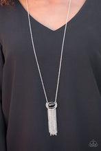 Load image into Gallery viewer, A black bead is pressed into the center of a rustic silver frame. Varying in shape and shimmer, glistening silver chains stream from the bottom of the whimsical pendant for a seasonal finish. Features an adjustable clasp closure.  Sold as one individual necklace. Includes one pair of matching earrings.  Always nickel and lead free.