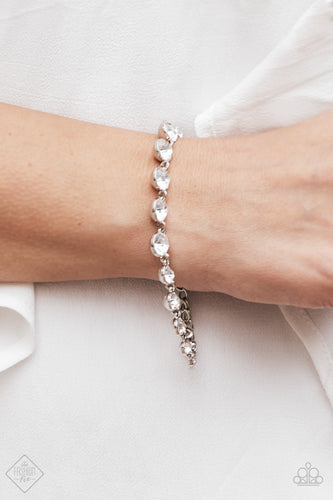 Gradually increasing in size towards the center, glittery white rhinestones link across the wrist for a timeless look. Features an adjustable clasp closure.  Sold as one individual bracelet.    Fiercely 5th Avenue Fashion Fix May 2018  . Always nickel and lead free.
