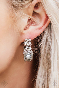 Dotted in shimmery silver textures, a frilly filigree hoop swings from the ear in a refined fashion. A pearly silver bead adorns the center of the hoop for a glamorous finish. Earring attaches to a standard post fitting. Hoop measures 1" in diameter.  Sold as one pair of hoop earrings.     Fiercely 5th Avenue Fashion Fix June 2018   