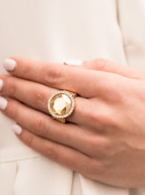 Load image into Gallery viewer, An oversized champagne gem is bordered by traditional white rhinestones. The heirloom-esque presence gives a nod to grandmother's jewelry box as it catches the eye and requests a second look. Features a stretchy band for a flexible fit.