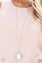 Load image into Gallery viewer,  A dramatically oversized white gem is suspended from the top of an airy silver frame, creating a hypnotic pendant at the bottom of a lengthened silver chain. As if dipped in glitter, the bottom of the silver frame is encrusted in glassy white rhinestones for a glamorous finish. Features an adjustable clasp closure.