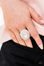 Load image into Gallery viewer, A white oval gem is pressed into the center of a stacked silver frame encrusted in row after row of a glassy white rhinestones for a spellbinding finish. Features a stretchy band for a flexible fit.