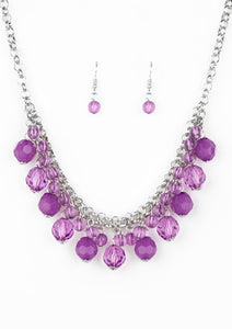 A collection of glassy and opaque purple crystal-like beads swing from the bottom of interlocking silver chains, creating a fabulous fringe below the collar. Features an adjustable clasp closure.  Sold as one individual necklace. Includes one pair of matching earrings.