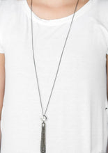 Load image into Gallery viewer, Infused with an elegantly elongated gunmetal chain, a dramatic white gem gives way to a shimmery gunmetal chain tassel for a glamorous look. Features an adjustable clasp closure.  Sold as one individual necklace. Includes one pair of matching earrings.  Always nickel and lead free.
