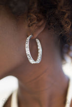 Load image into Gallery viewer, The front facing surface of a chunky silver hoop is dipped in brilliantly sparkling rhinestones while light-catching texture wraps around the back. The interior of the hoop features the opposite pattern, creating the illusion of a full hoop of blinding rhinestones. Earring attaches to a standard post fitting. Hoop measures 1 3/4" in diameter.  Sold as one pair of earrings.   Blockbuster!!