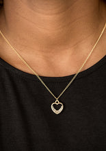 Load image into Gallery viewer, A glistening ribbon of gold curls into a romantic heart-shaped pendant below the collar. Glittery white rhinestones dust the inside of the whimsical frame, adding refined shimmer to the timeless palette. Features an adjustable clasp closure.  Sold as one individual necklace. Includes one pair of matching earrings.