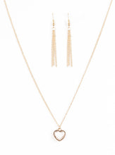 Load image into Gallery viewer, A glistening ribbon of gold curls into a romantic heart-shaped pendant below the collar. Glittery white rhinestones dust the inside of the whimsical frame, adding refined shimmer to the timeless palette. Features an adjustable clasp closure.  Sold as one individual necklace. Includes one pair of matching earrings.