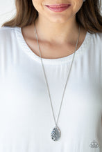 Load image into Gallery viewer, Stenciled in a whimsical floral pattern, an airy silver teardrop frame overlaps a glowing gray cat's eye stone, creating a colorful pendant at the bottom of a lengthened silver chain. Features an adjustable clasp closure.  Sold as one individual necklace. Includes one pair of matching earrings.   Always nickel and lead free.