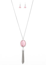 Load image into Gallery viewer, An oversized pink cat's eye stone frame gives way to a shimmery silver chain tassel, creating a whimsically stacked pendant at the bottom of a lengthened silver chain. Features an adjustable clasp closure.  Sold as one individual necklace. Includes one pair of matching earrings.
