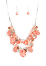 Load image into Gallery viewer, What better way to say "hello spring" than with this vibrant stunner? Double the fun with two layers of beads, baubles, stone, and wood in varying tones and finishes in the Pantone® of Burnt Coral, intermixed with sparkling, wavy silver discs gently swaying from a silver chain. Features an adjustable clasp closure.