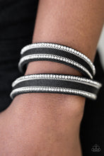 Load image into Gallery viewer, An elongated black suede band is encrusted in rows of glassy white rhinestones and shimmery silver chains. The elongated band double wraps around the wrist for a fierce one-of-a-kind look. Features an adjustable snap closure.  Sold as one individual bracelet.   Always nickel and lead free.