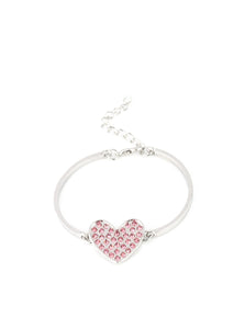 A pink rhinestone encrusted silver heart frame delicately links to two dainty silver bars arcing around the wrist, creating a dazzling centerpiece. Features an adjustable clasp closure.  Sold as one individual bracelet.  