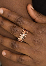 Load image into Gallery viewer, Trios of shimmery copper studs dot the top and bottom of an antiqued copper band for an edgy industrial look. Features a dainty stretchy band for a flexible fit.  Sold as one individual ring.