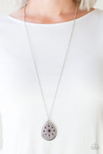 Load image into Gallery viewer, A dramatic teardrop pendant swings from the bottom of an elongated silver chain, elegantly slimming the torso. Glittery purple rhinestones are sprinkled along the pendant as silver filigree dances across the center, creating a regal floral pattern. Features an adjustable clasp closure.  Sold as one individual necklace. Includes one pair of matching earrings.