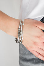 Load image into Gallery viewer, A collection of mismatched silver beads are threaded along three stretchy spring-like wires for a sleek industrial look.  Sold as one set of three bracelets.  Always nickel and lead free.