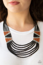 Load image into Gallery viewer, Separated by shimmery silver fittings, black, brown, and silver seed beaded geometric frames give way to layers of black seed beads down the chest for a tribal inspired flair. Features an adjustable clasp closure.  Sold as one individual necklace and earring set.  Always nickel and lead free!
