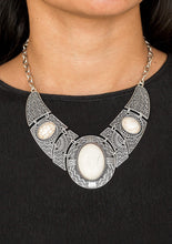 Load image into Gallery viewer, Gradually increasing in size, dramatically oversized smoky gems are pressed into the centers of hammered and silver studded frames. The blinding frames link below the collar for a glamorous, statement-making finish. Features an adjustable clasp closure.  Sold as one individual necklace. Includes one pair of matching earrings.