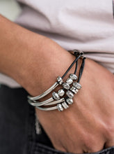 Load image into Gallery viewer, Multiple strands of black cord are fitted with long, curved cylinders that meet in the middle. The sliding bars are separated by small antiqued silver loops that mimic pipe fittings, making this a perfect addition to any industrial look. Features an adjustable clasp closure.