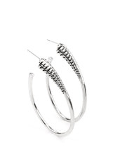 Load image into Gallery viewer,  A spiral of texture resembling a coil anchors an exaggerated oblong silver hoop that wraps around the ear. The high-sheen finish on the curved bar adds a hint of drama, as it refracts the light in a knockout finish. Earring attaches to a standard post fitting. Hoop measures approximately 1 1/2" in diameter.