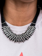 Load image into Gallery viewer,  Bold and unapologetic, this hefty necklace gives off a hand-made feel with its multiple strands of black cording held together by industrial silver fittings that shift and slide. Features an adjustable clasp closure.