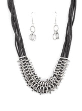 Load image into Gallery viewer, Bold and unapologetic, this hefty necklace gives off a hand-made feel with its multiple strands of black cording held together by industrial silver fittings that shift and slide. Features an adjustable clasp closure.