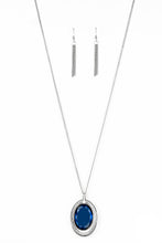 Load image into Gallery viewer, An oversized blue gem swings from the top of an airy silver frame, creating a refined double pendant at the bottom of a lengthened silver chain. As if dipped in glitter, the bottom of the silver frame is encrusted in glassy white rhinestones for a glamorous finish. Features an adjustable clasp closure.  Sold as one individual necklace. Includes one pair of matching earrings.