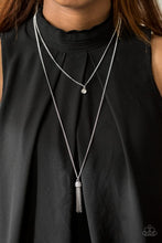 Load image into Gallery viewer,  A solitaire white rhinestone swings from the uppermost chain above a shimmery silver bead encrusted in glassy white rhinestones. Glistening silver chains stream from the bottom of the sparkling bead, creating a refined tassel. Features an adjustable clasp closure.  Sold as one individual necklace. Includes one pair of matching earrings.  Always nickel and lead free.
