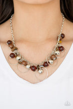 Load image into Gallery viewer, Glassy brown, polished brown, and classic silver chains swing from the bottom of a shimmery silver chain. Infused with large silver hoops, bits of tranquil brown rock beading trickle between the beaded accent, creating an earthy fringe below the collar. Features an adjustable clasp closure.  Sold as one individual necklace. Includes one pair of matching earrings.  Always nickel and lead free.