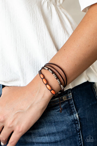 Infused with dainty silver and refreshing orange stone beads, mismatched strands of braided twine-like cord and brown leather pieces delicately layer across the wrist for a colorfully earthy look. Features an adjustable sliding knot closure.  Sold as one individual bracelet.  Always nickel and lead free.