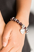 Load image into Gallery viewer, Sparkling purple crystal-like beads and shimmery silver accents are threaded along a stretchy band. An over-sized silver heart charm swings from the wrist for a whimsical finish.  Sold as one individual bracelet. Always nickel and lead free.