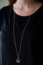Load image into Gallery viewer, Gold circles join into an alluring 3-D box. A detached white gem freely sits in the gold box creating the illusion of a floating gem. The bright gold and dazzling gem create an incandescent design. Features an adjustable clasp feature.  Sold as one individual necklace. Includes one pair of matching earrings.