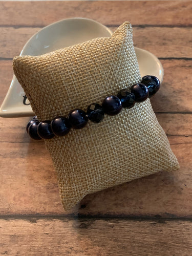 Infused with three metallic crystal-like beads, a refined collection of blue pearls is threaded along a stretchy band around the wrist in a timeless fashion.  Sold as one individual bracelet.  Always nickel and lead free.  Fashion Fix Exclusive!