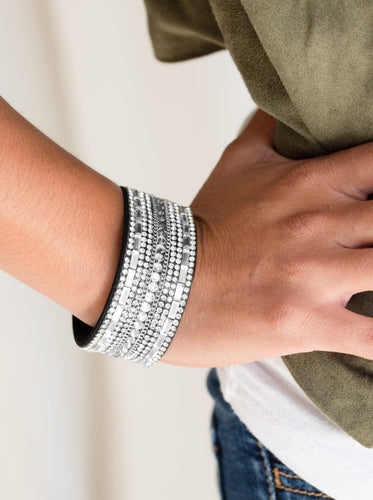   Featuring classic round and edgy emerald style cuts, glittery white rhinestones and glistening silver chains are encrusted along bands of black suede for a sassy look. Features an adjustable snap closure.  Sold as one individual bracelet.
