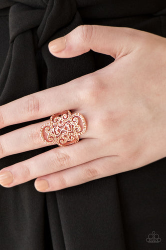   Dainty peach rhinestones are encrusted along a shiny copper frame radiating with regal filigree for a refined look. Features a stretchy band for a flexible fit.  Sold as one individual ring.  Always nickel and lead free.