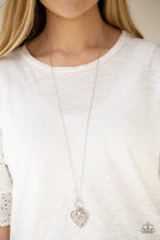 Load image into Gallery viewer, Infused with dainty brown pearls and a shimmery silver heart charm, a stenciled silver heart pendant swings from the bottom of a lengthened silver chain for a whimsical look. Features an adjustable clasp closure.  Sold as one individual necklace. Includes one pair of matching earrings.  Always nickel and lead free.