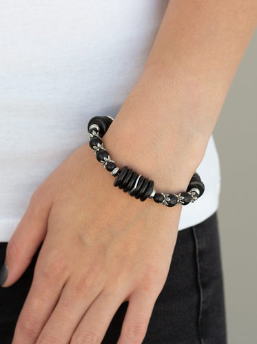   Featuring glistening silver accents, disc-shaped and round black stone beads are threaded along a stretchy band for a seasonal look.  Sold as one individual bracelet. 
