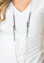 Load image into Gallery viewer, Brushed in a metallic sheen, glittery blue crystal-like beads join faceted silver beads along layers of shimmery silver chains for a refined look. Features an adjustable clasp closure.