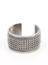 Load image into Gallery viewer, Finished in antiqued silver, a thick silver cuff is filled with rows of dotted texture and bordered by a raised linear frame, resulting in a bold statement piece.