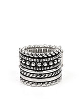 Load image into Gallery viewer, Layers of texture - from rows of dots to twisted ropes to high sheen hammered silver - stack together in a bold display. Features a stretchy band for a flexible fit.